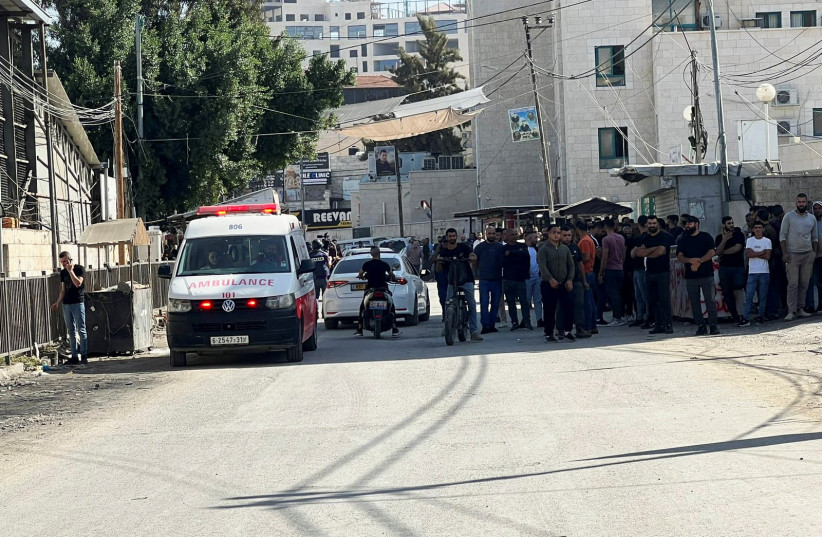  Palestinians wait in front of a hospital during an Israeli raid in Jenin in the West Bank November 9,2023. (credit: RANEEN SAWAFTA/REUTERS)