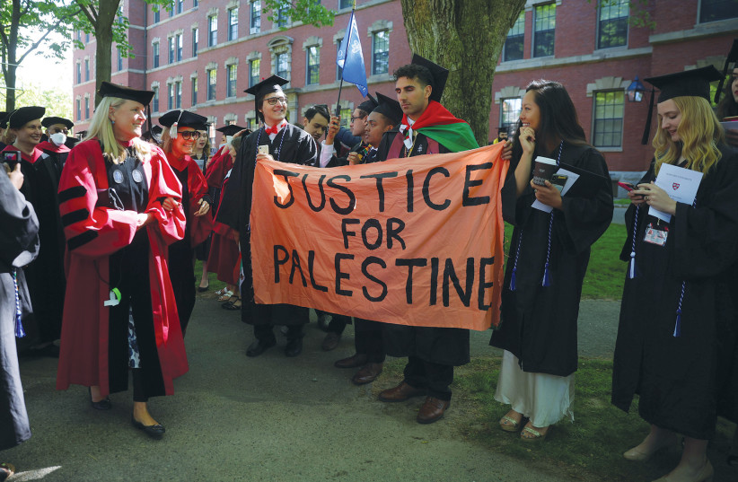  GRADUATING STUDENTS hold up a sign that reads ‘Justice for Palestine’ during Harvard University commencement exercises, in Cambridge, Massachusetts, in May 2022. (credit: BRIAN SNYDER/REUTERS)
