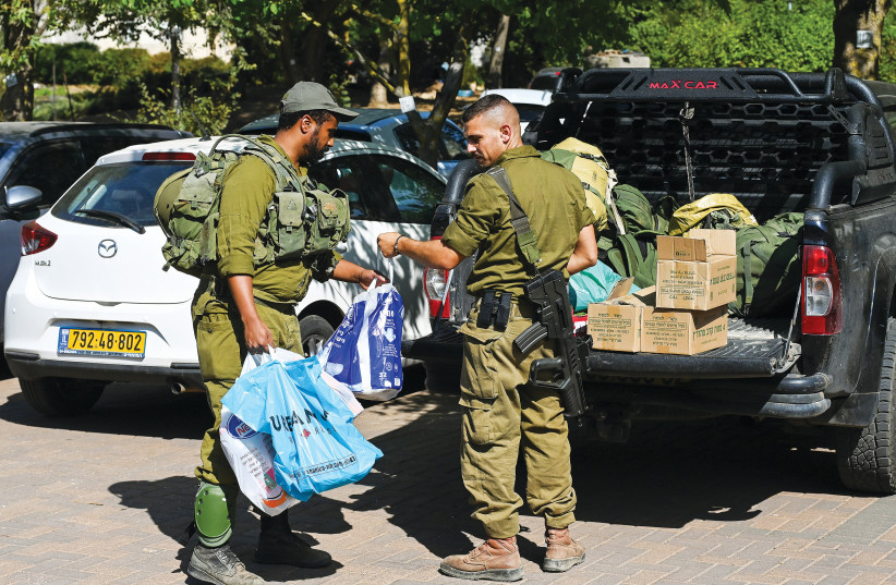 IDF RESERVISTS unpack their belongings after being called up to duty after the October 7 massacre.