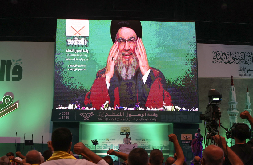  Lebanon's Hezbollah leader Sayyed Hassan Nasrallah addresses his supporters via a screen during a rally marking Prophet Mohammed's birthday, in Beirut suburbs, Lebanon October 2, 2023. (credit: MOHAMED AZAKIR/REUTERS)