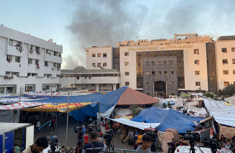  Smoke rises as displaced Palestinians take shelter at Al Shifa hospital, amid the ongoing conflict between Hamas and Israel, in Gaza City, November 8, 2023. (credit: REUTERS/DOAA ROUQA)