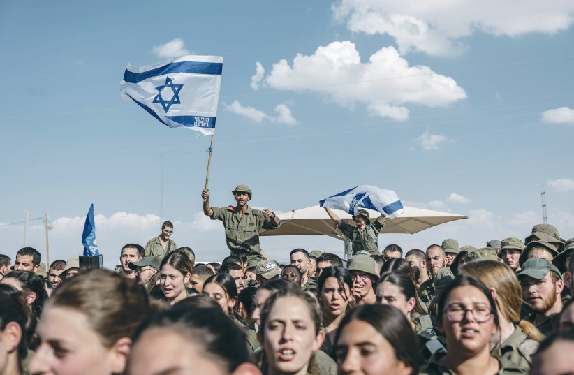  SOLDIERS DANCE at a concert by singer Idan Raichel at an army base in the South, last month. In these days of trauma and war there may be room for optimism, says the writer. (credit: CHEN SCHIMMEL/FLASH90)