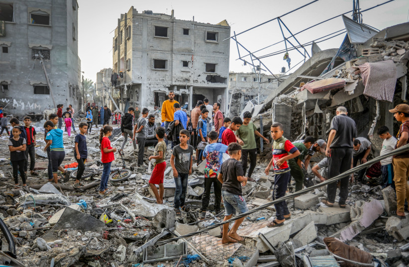 Palestinians at the rubble of a destroyed building from Israeli airstrikes in Rafah, in the southern Gaza Strip, on November 11, 2023.  (credit: ABED RAHIM KHATIB/FLASH90)