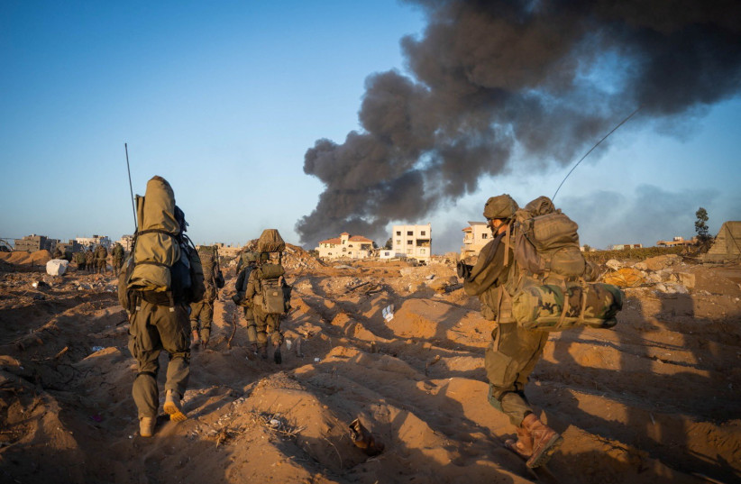  Israeli soldiers take position, amid the ongoing ground operation of the Israeli army against Palestinian Islamist group Hamas, in the Gaza Strip as seen in a handout picture released by the Israel Defense Forces on November 12, 2023. (credit: IDF/Handout via REUTERS)