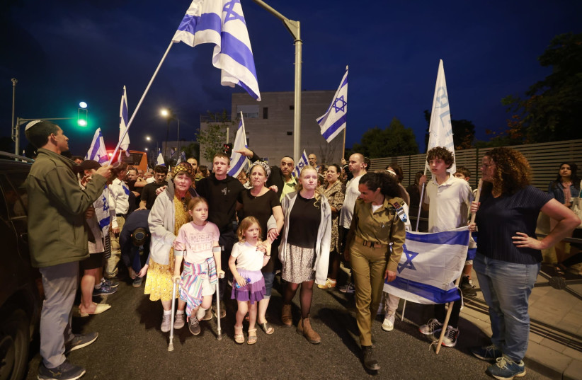 The family of Sgt. Maj. (res) Yossi Hershkovitz arrive at the school where he was principle to supportive crowds of students, parents, colleagues, November 12, 2023. (credit: MARC ISRAEL SELLEM)