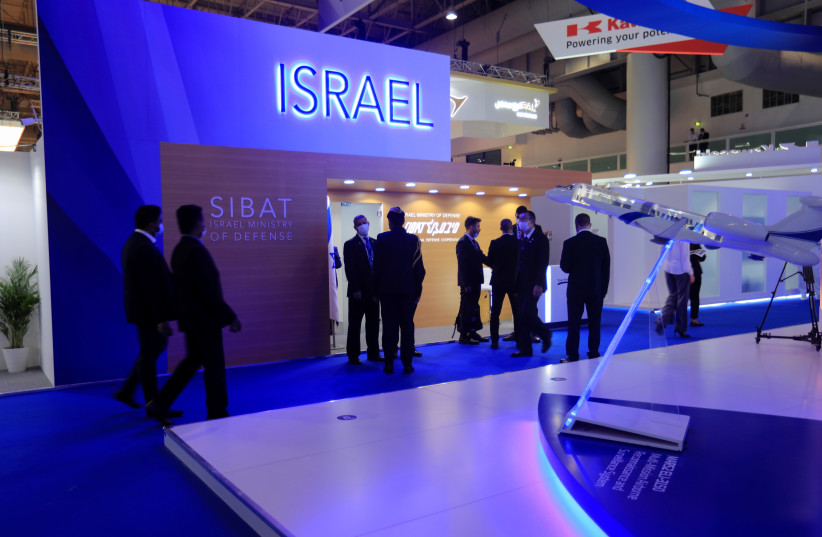  People walk past the Israeli display during the Dubai Air Show in Dubai, United Arab Emirates, November 14, 2021.  (credit: REUTERS)