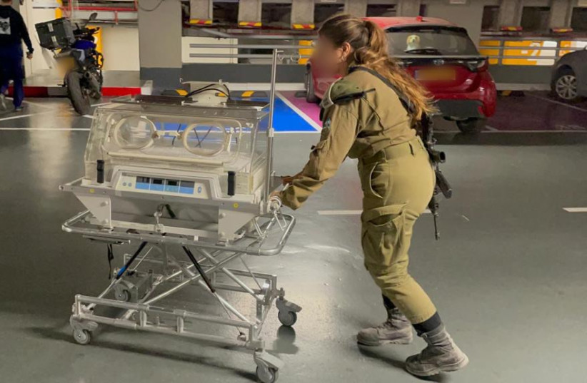  An IDF soldier moves an incubator to be delivered to Al-Shifa Hospital in Gaza. November 14, 2023. (credit: IDF)