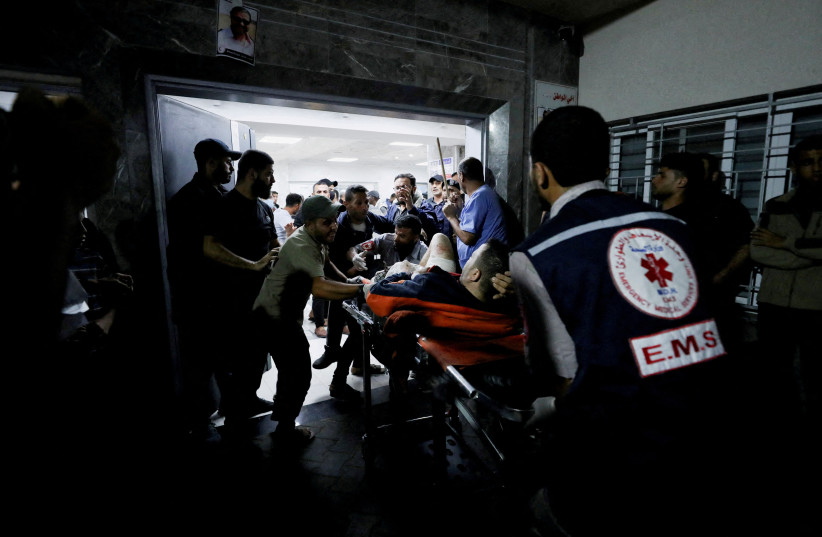  People are assisted at Shifa Hospital after hundreds of Palestinians were killed in a blast at Al-Ahli hospital in Gaza that Israeli and Palestinian officials blamed on each other (credit: REUTERS)