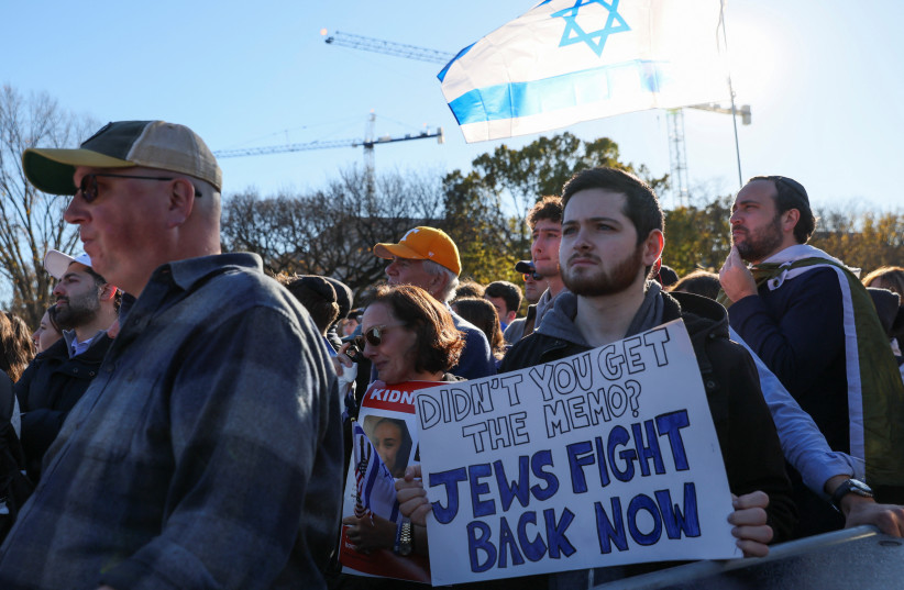  A person holds a placard as Israeli Americans and supporters of Israel gather in solidarity with Israel and protest against antisemitism, amid the ongoing conflict between Israel and the Palestinian group Hamas, during a rally on the National Mall in Washington, US, November 14, 2023. (credit: Leah Mills/Reuters)