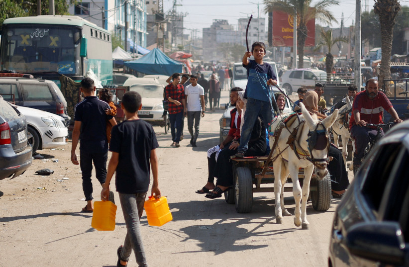 Palestinians use a donkey-drawn cart as a means of transportation, as the strip suffers from a lack of fuel, amid the ongoing conflict with Israel, in Khan Younis in the southern Gaza Strip October 31, 2023. (credit: REUTERS/MOHAMMED SALEM)