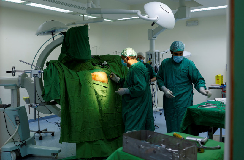 Doctor Moussa Abbas performs a surgery in Tebnin governmental hospital, in Tebnin, southern Lebanon November 10, 2023. (credit: ALAA AL-MARJANI/REUTERS)