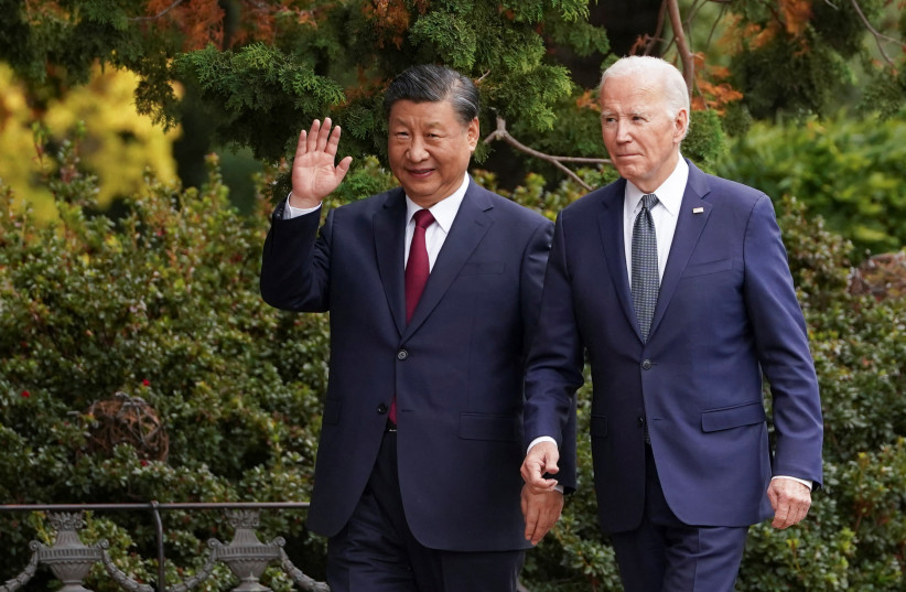 Chinese President Xi Jinping waves as he walks with US President Joe Biden at Filoli estate on the sidelines of the Asia-Pacific Economic Cooperation (APEC) summit, in Woodside, California, November 15th, 2023. (credit: REUTERS/KEVIN LAMARQUE)