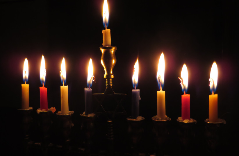  A Hanukkah menorah with lit candles. (credit: PXHERE)