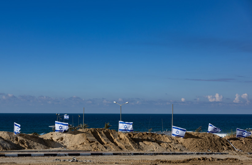  Israeli flags at the beach in the northern Gaza Strip, during an Israeli military operation in the Gaza Strip, November 16, 2023.  (credit: YONATAN SINDEL/FLASH90)