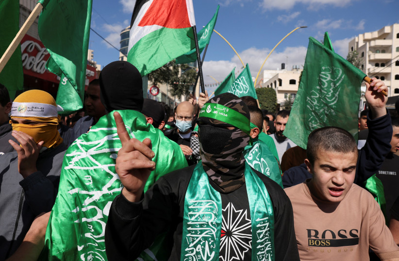  Palestinians take part in a protest in support of Hamas, in Hebron, the West Bank, November 17, 2023 (credit: REUTERS/MUSSA QAWASMA)