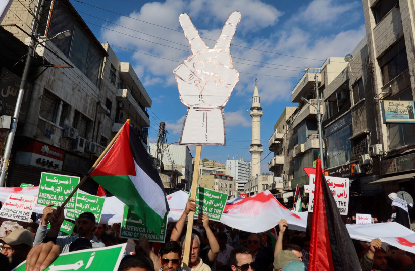  Demonstrators carry banners and flags during a protest in support of Palestinians in Gaza, amid the ongoing conflict between Israel and the Palestinian Islamist group Hamas, in Amman, Jordan November 17, 2023.  (credit: REUTERS/JEHAD SHELBAK)
