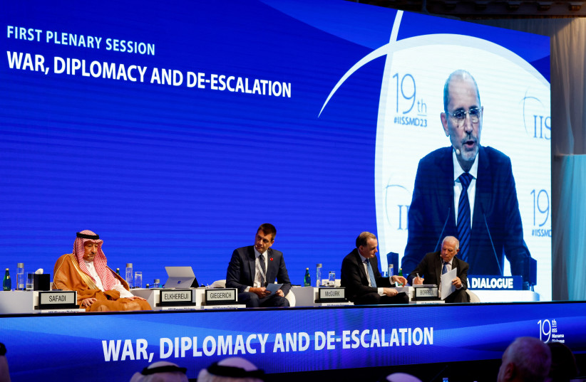  Delegates attend as Jordanian Foreign Minister Ayman Safadi appears on a screen while speaking at the IISS Manama Dialogue in Manama, Bahrain, November 18, 2023 (credit: REUTERS/HAMAD I MOHAMMED)