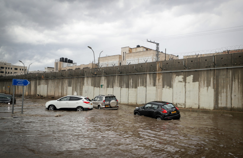 Cars on flooded streets Qalandia, outside of Jerusalem, following heavy rain.  November 01, 2023 (credit: JAMAL AWAD/FLASH90)