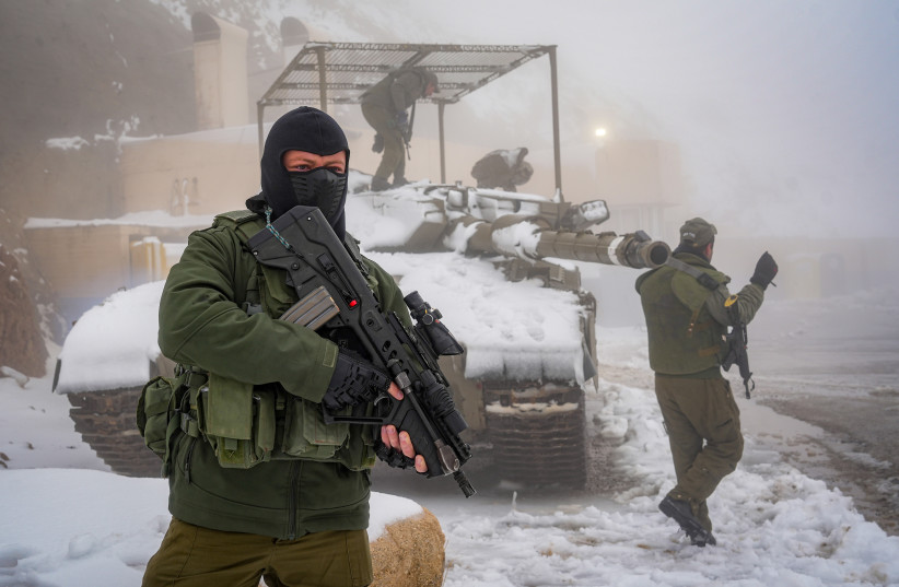  Israeli soldiers patrol in the snow in Mount Hermon, near the Israeli border with Lebanon, northern Israel, November 20, 2023 (credit: AYAL MARGOLIN/FLASH90)