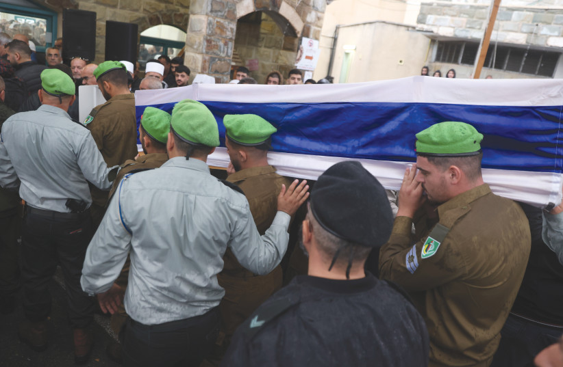  FAMILY AND FRIENDS of IDF solider Adi Malik mourn at his funeral in the Druze village of Beit Jann on Sunday, after he was killed during the ground operation in the Gaza strip (credit: David Cohen/Flash90)