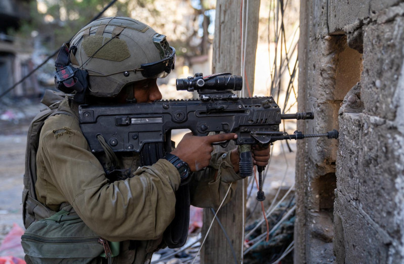  An IDF soldier takes position in Gaza, amid Israel's ongoing ground operation against the Palestinian Islamist terrorist group Hamas, in this handout image released on November 21, 2023. (credit: IDF/Handout via REUTERS)