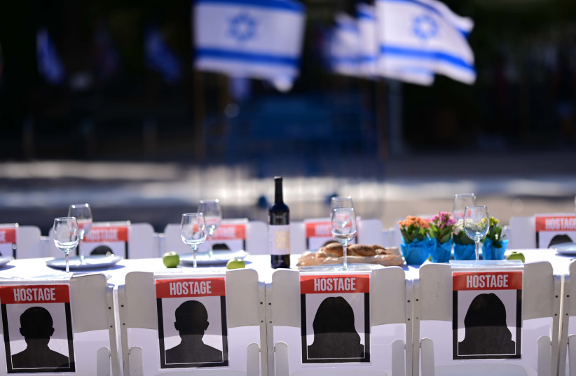  Families of Israelis held hostage by Hamas militants in Gaza set a symbolic shabbat table with more than 200 empty seats for the hostages, at  ''Hostage Square'', outside the Art Museum of Tel Aviv, October 20, 2023.  (credit: TOMER NEUBERG/FLASH90)