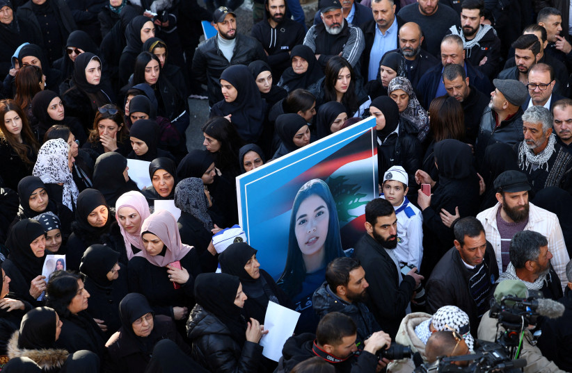  Mourners hold a picture of Farah Omar, Lebanon-based Al Mayadeen TV channel correspondent, who was killed along with Al Mayadeen cameraman Rabih al-Maamari by what their channel said was an Israeli strike in southern Lebanon, during her funeral in Mashghara, Lebanon, November 22, 2023. (credit: REUTERS/ESA ALEXANDER)