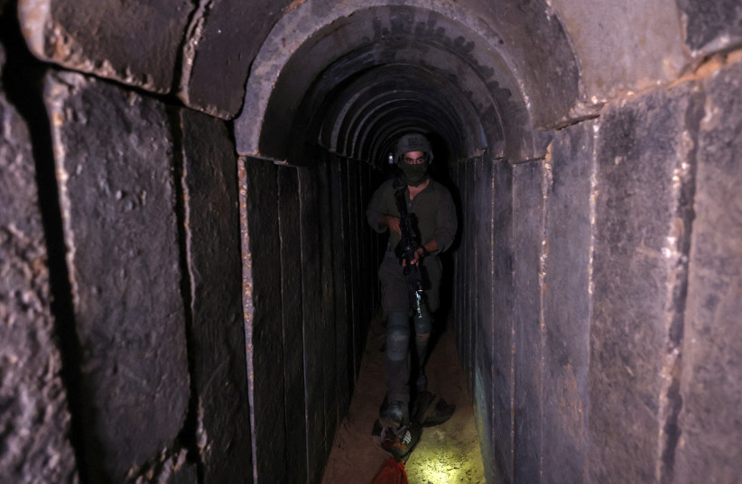  An Israeli soldier walks through a tunnel underneath Al Shifa Hospital in Gaza City, November 22, 2023 (credit: RONEN ZVULUN/REUTERS)