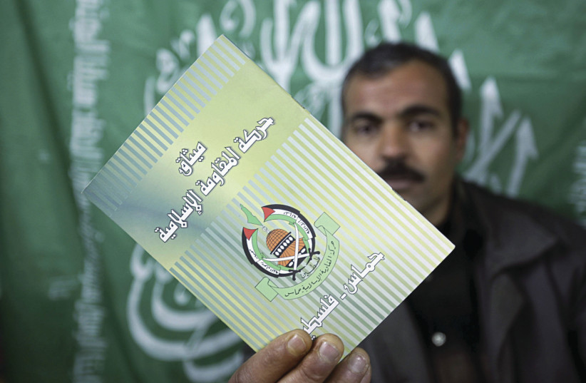  HAMAS CHARTER: A movement member in Gaza brandishes a copy.  (credit: Abid Katib/Getty Images)