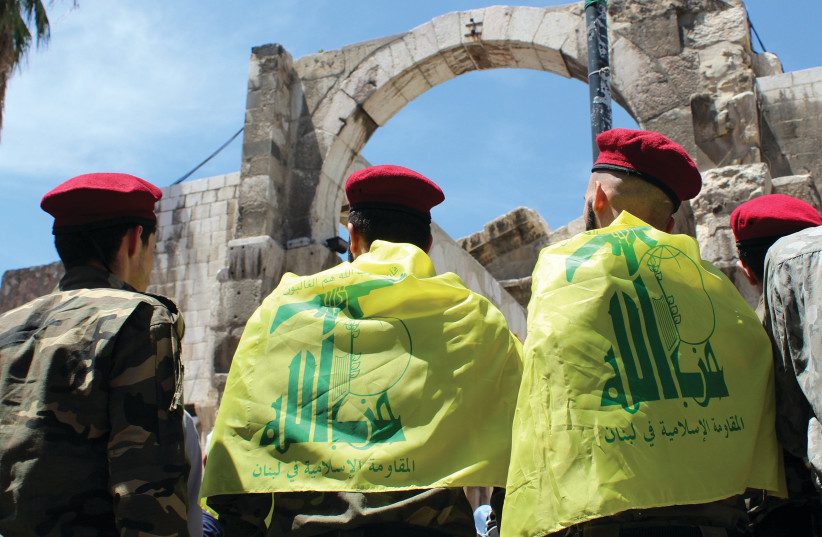  PALESTINIANS LIVING in Syria wear Hezbollah flags at a demonstration in Damascus marking the annual al-Quds Day. (credit: FIRAS MAKDESI/REUTERS)