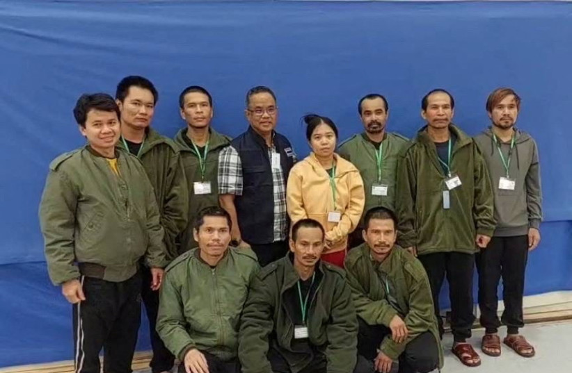  Thai workers taken hostage by Hamas and later released as part of a deal between Israel and Palestinian terrorist group Hamas, pose with a member of Thai mission after a medical checkup, in Tel Aviv, Israel, in this handout image released on November 25, 2023. (credit: Ministry Of Foreign Affairs Thailand/Handout via REUTERS)