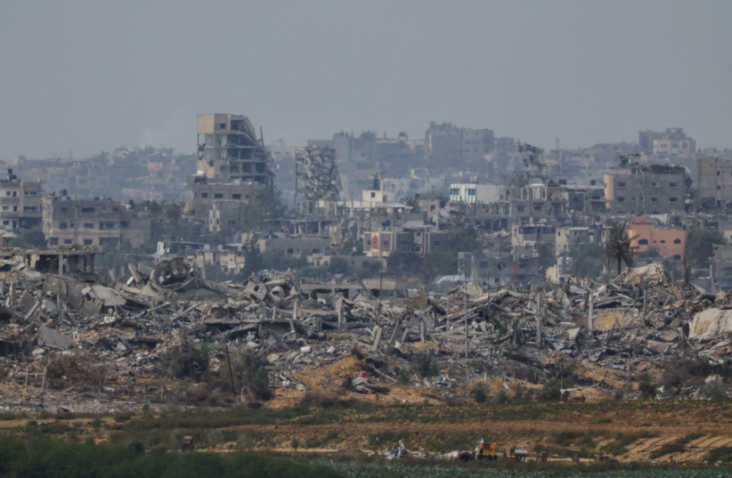 Destroyed buildings lay in ruin in Gaza, as seen from southern Israel, during the temporary truce between Hamas and Israel, November 25, 2023 (credit: REUTERS/ALEXANDER ERMOCHENKO)