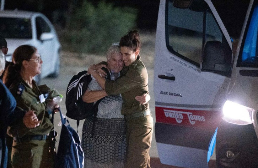 Hannah Katzir hugs members of the IDF after finally reaching Israeli soil, 24 November 2023. (credit: IDF SPOKESPERSON UNIT)