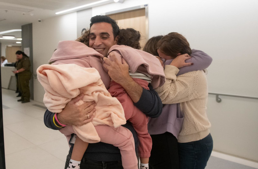 Aviv Asher, 2.5 years old, her sister Raz Asher, 4.5 years old, and mother Doron reunited. (credit: IDF SPOKESPERSON UNIT)