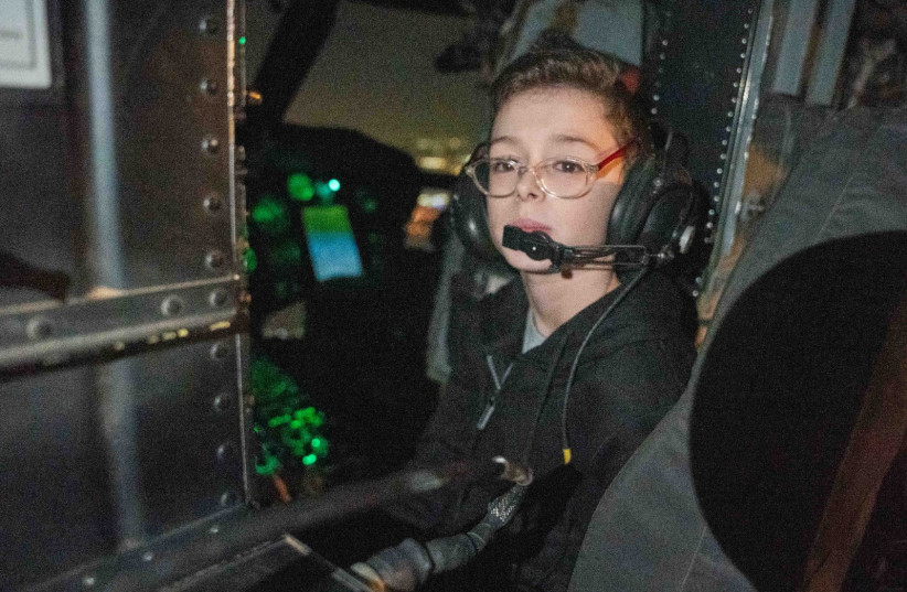  Ohad Munder, who spent his 9th birthday as a hostage, sits in a helicopter on his journey back to Israel. (credit: IDF SPOKESMAN’S UNIT)