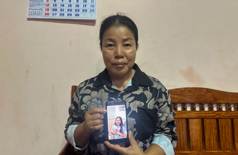 Bunyarin Srijan, the mother of a Thai hostage released as part of a hostages-prisoners swap deal between Hamas and Israel, holds her phone showing an image of her daughter, Natthawaree Mulkan, during an interview at her home in Khon Kaen, Thailand November 25, 2023. (credit:  REUTERS/Napat Wesshasartar)
