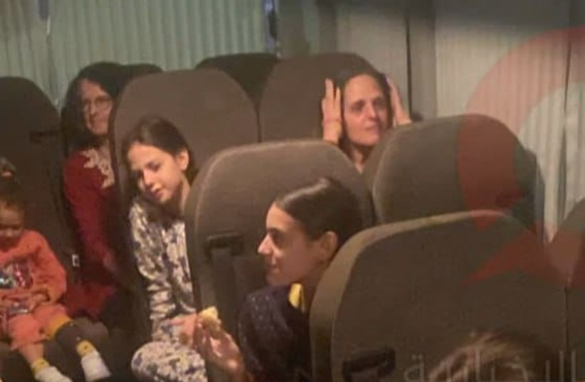  Israeli hostages, who had spent 50 days in captivity in Gaza, are seen on a bus returning to Israel after their release on Saturday, November 25, 2023. (credit: screenshot)