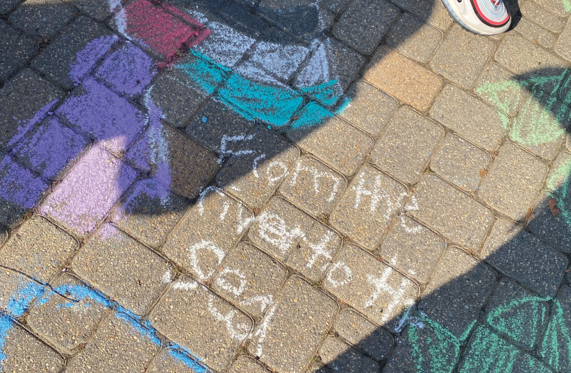  A CHALKING at a Students for Justice in Palestine event at the University of Maryland includes a Palestinian flag along with ‘From the river to the sea.’ (credit: KEREN BINYAMIN)
