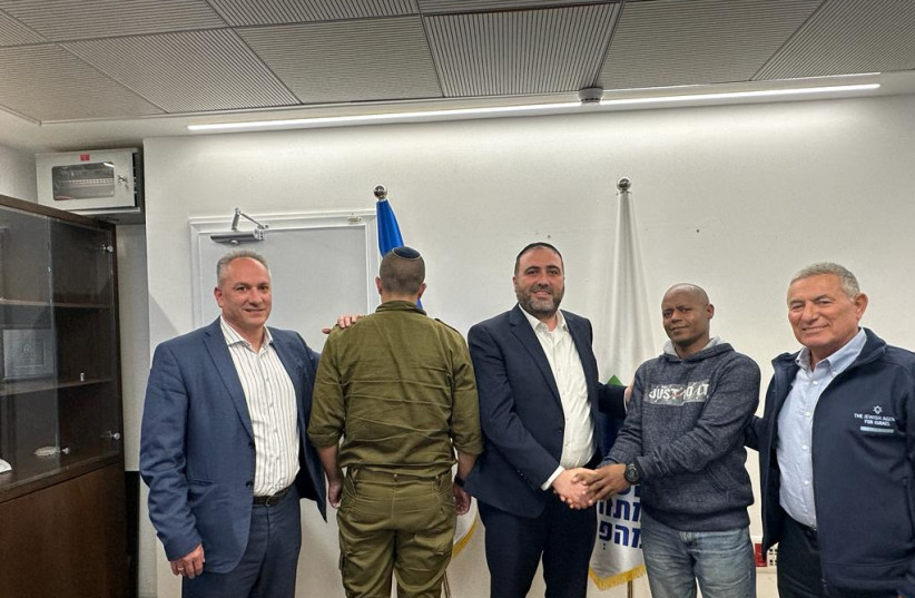 Interior Minister Moshe Arbel (third from left) shakes hands with Molugata Tsagai, to his right, who saved the life of Lt. Col Y, on Arbel's left, during Hamas's October 7 attack, November 26, 2023.  (credit: COURTESY INTERIOR MINISTRY)