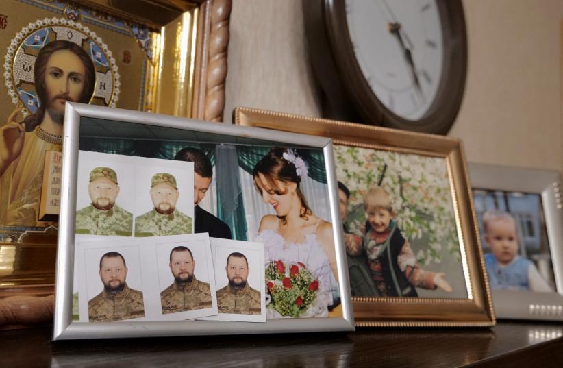  A view of framed pictures of Antonina Danylevych and her husband Oleksandr, who has been fighting against Russia's invasion on Ukraine since March 2022, in their apartment in Kyiv, November 9, 2023 (credit: REUTERS/CHARLOTTE BRUNEAU)