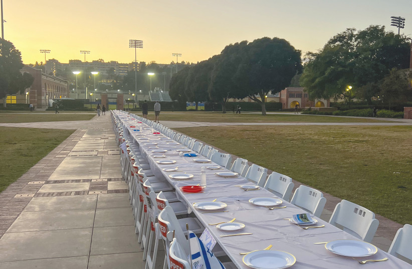  AN EMPTY Shabbat table is set in Wilson Plaza on UCLA's campus earlier this month at a pro-Israel protest, representing the hostages held by Hamas and missing Shabbat dinners with their families. (credit: EMILY SAMUELS )