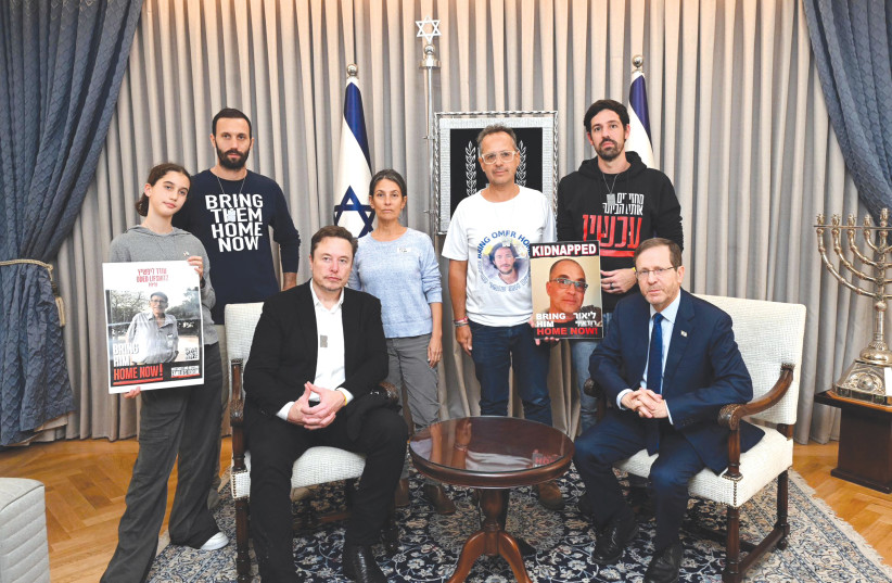  Elon Musk (left, sitting) meets with President Isaac Herzog and families of hostages held in Gaza, during his visit to Israel this week. (credit: HAIM ZACH/GPO)
