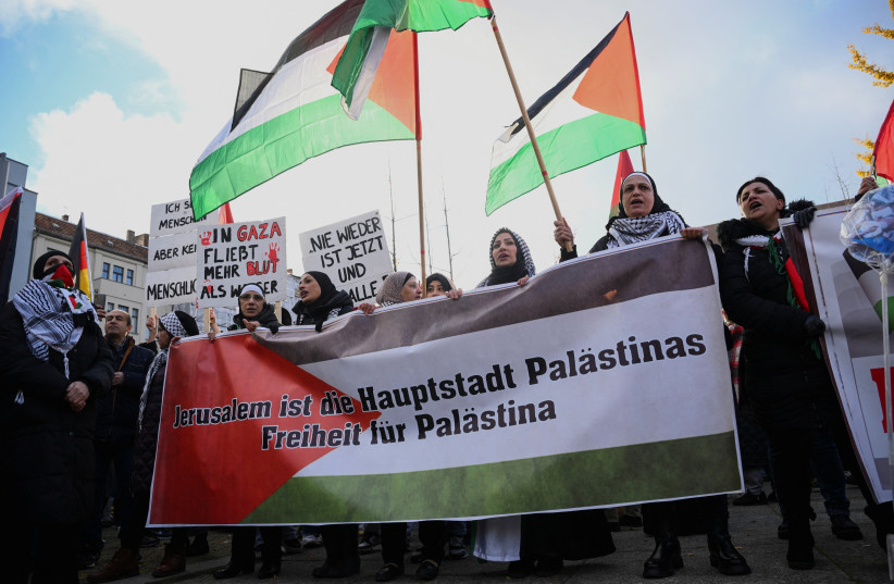  People hold a banner reading ''Jerusalem is the capital of Palestine Freedom for Palestine'' as they take part in a demonstration in solidarity with Palestinians in Gaza, amid the ongoing conflict between Israel and the Palestinian terrorist group Hamas, in Berlin, Germany November 18, 2023.  (credit: REUTERS/ANNEGRET HILSE)