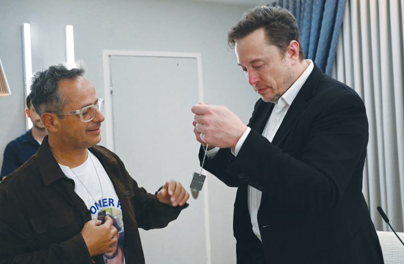 ELON MUSK puts on a symbolic dog tag.