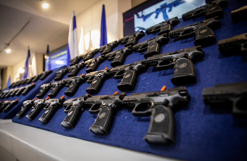  Illegal weapons are displayed during a ceremony in Ma'ale Adumim, after a large police operation against illegal gun dealers, September 7, 2022. (credit: OREN BEN HAKOON/FLASH90)