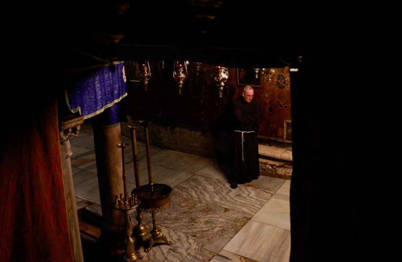   A monk stands inside the Church of the Nativity on the day of the launch of the beginning of the Christmas season, as the conflict between Israel and Hamas continues, in Bethlehem in the West Bank, December 2, 2023. (credit: REUTERS/AMMAR AWAD)