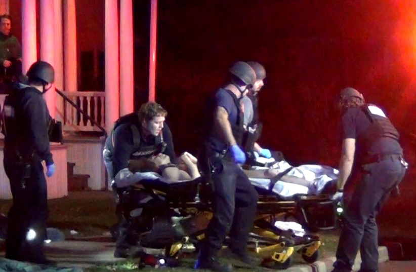  First responders wheel a victim to an ambulance after a gunman shot and wounded three college students of Palestinian descent in Burlington, Vermont, U.S. November 25, 2023 in a still image from video.  (credit: Courtesy Wayne Savage via REUTERS./File Photo)
