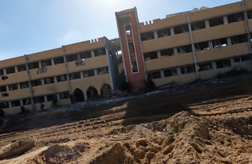  Israeli soldiers enter the school, near which the army located Hamas tunnel shaft, during the ongoing ground operation of the Israeli army against Hamas, in a location given as Beit Lahiya, in Gaza, in this handout still image obtained from a video released on December 2, 2023. (credit: Israel Defense Forces/Handout via REUTERS)