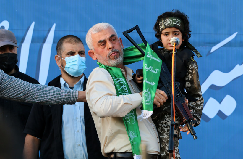 Yahya Sinwar, leader of the Palestinian Hamas terrorist movement, gestures on stage during a rally in Gaza City. May 24, 2021.  (credit: ATIA MOHAMMED/FLASH90)
