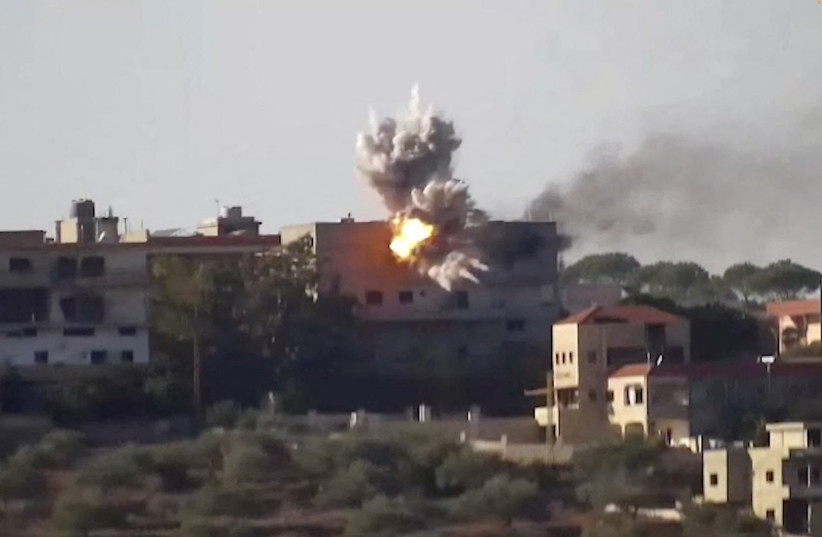  Smoke and fire rise from a building following an Israeli airstrike on Hezbollah targets in Lebanon, amid the ongoing cross-border hostilities between Hezbollah and the IDF, in this screengrab taken from an undated handout video released on November 24, 2023. (credit: IDF/Handout via REUTERS)